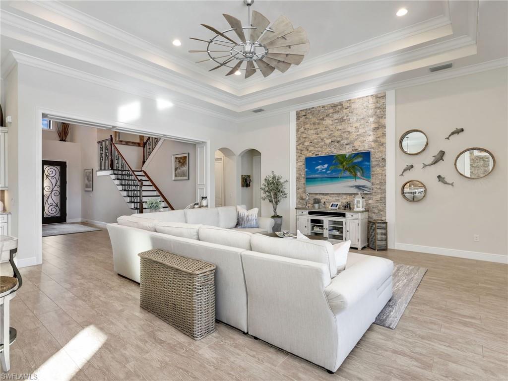 12757 Dundee Lane Naples, FL 34120 - Photo 11 of 48 a living room with furniture and a flat screen tv