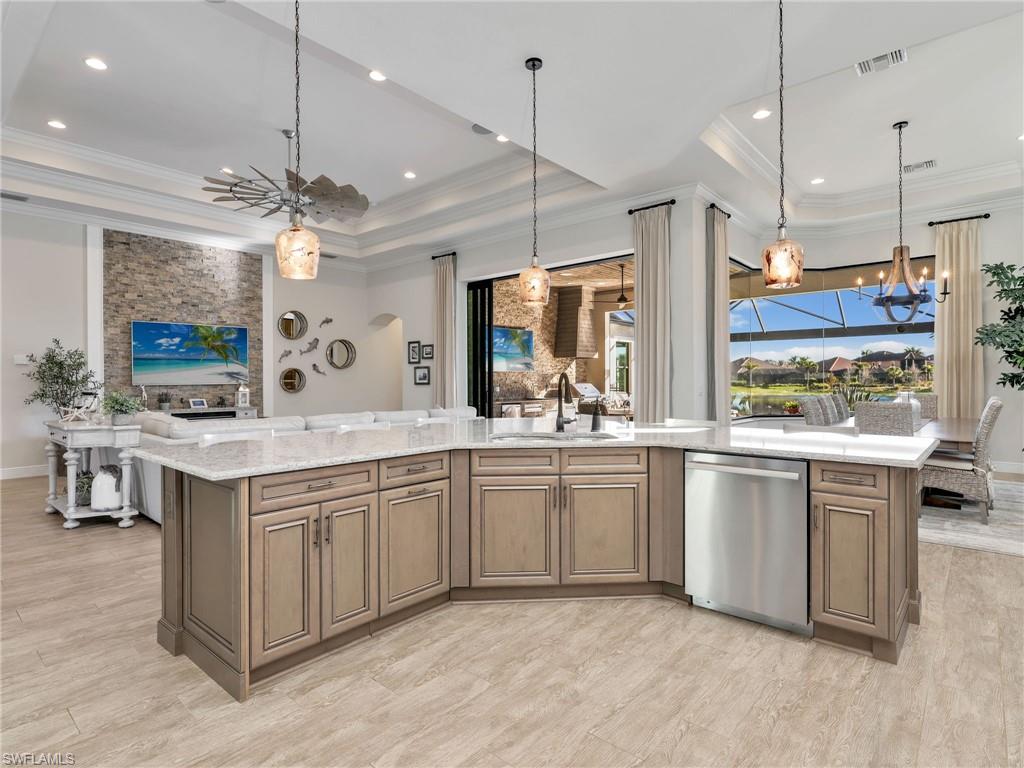 12757 Dundee Lane Naples, FL 34120 - Photo 13 of 48 a kitchen with kitchen island granite countertop lots of counter top space and stainless steel appliances