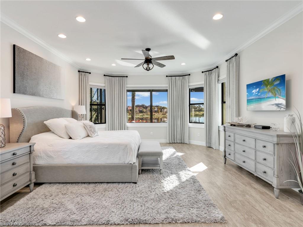 12757 Dundee Lane Naples, FL 34120 - Photo 18 of 48 a bedroom with a large bed and a window