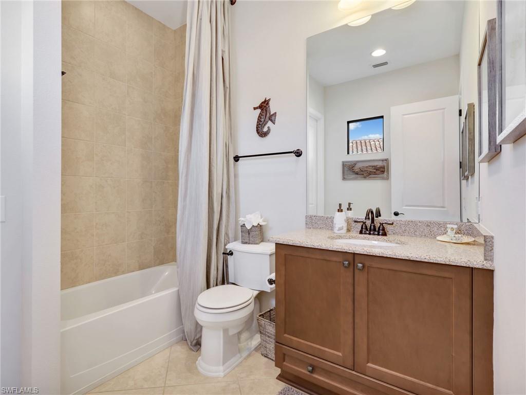 12757 Dundee Lane Naples, FL 34120 - Photo 23 of 48 a white toilet sitting next to a bathroom sink