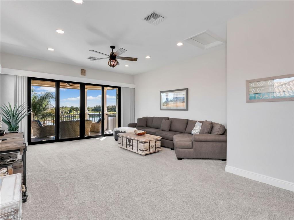 12757 Dundee Lane Naples, FL 34120 - Photo 25 of 48 a living room with furniture ceiling fan and a large window