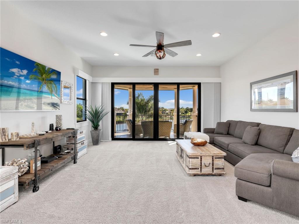 12757 Dundee Lane Naples, FL 34120 - Photo 26 of 48 a living room with furniture and large windows