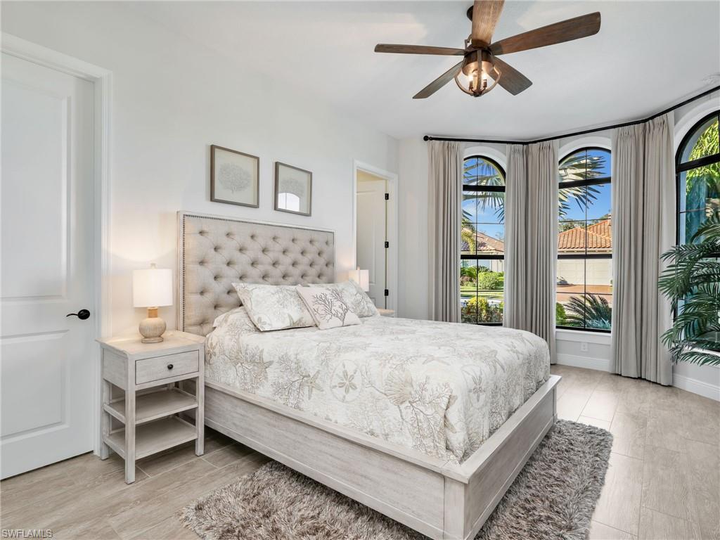 12757 Dundee Lane Naples, FL 34120 - Photo 30 of 48 a bedroom with a large bed and a window