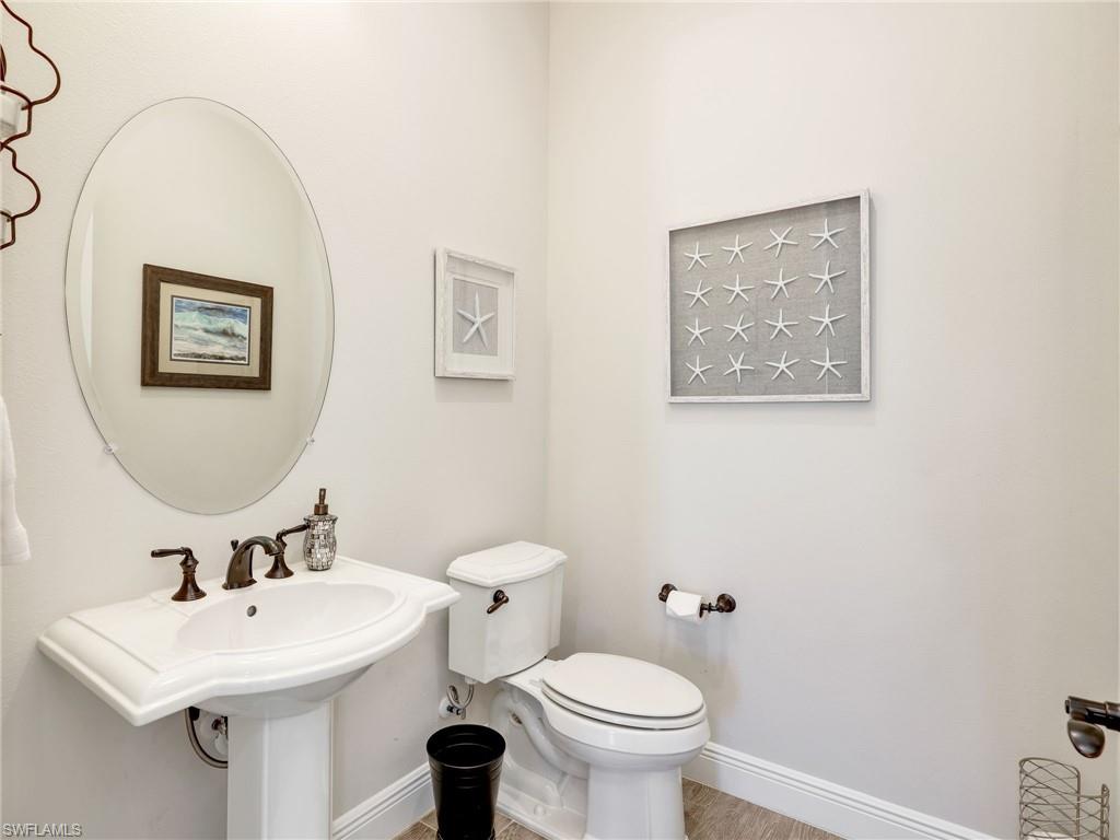 12757 Dundee Lane Naples, FL 34120 - Photo 33 of 48 a bathroom with a toilet a sink and mirror
