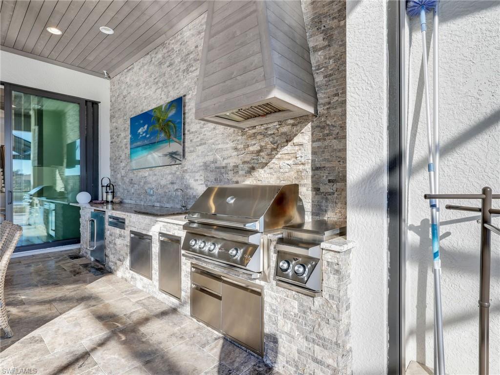 12757 Dundee Lane Naples, FL 34120 - Photo 36 of 48 a kitchen with a stove and a refrigerator