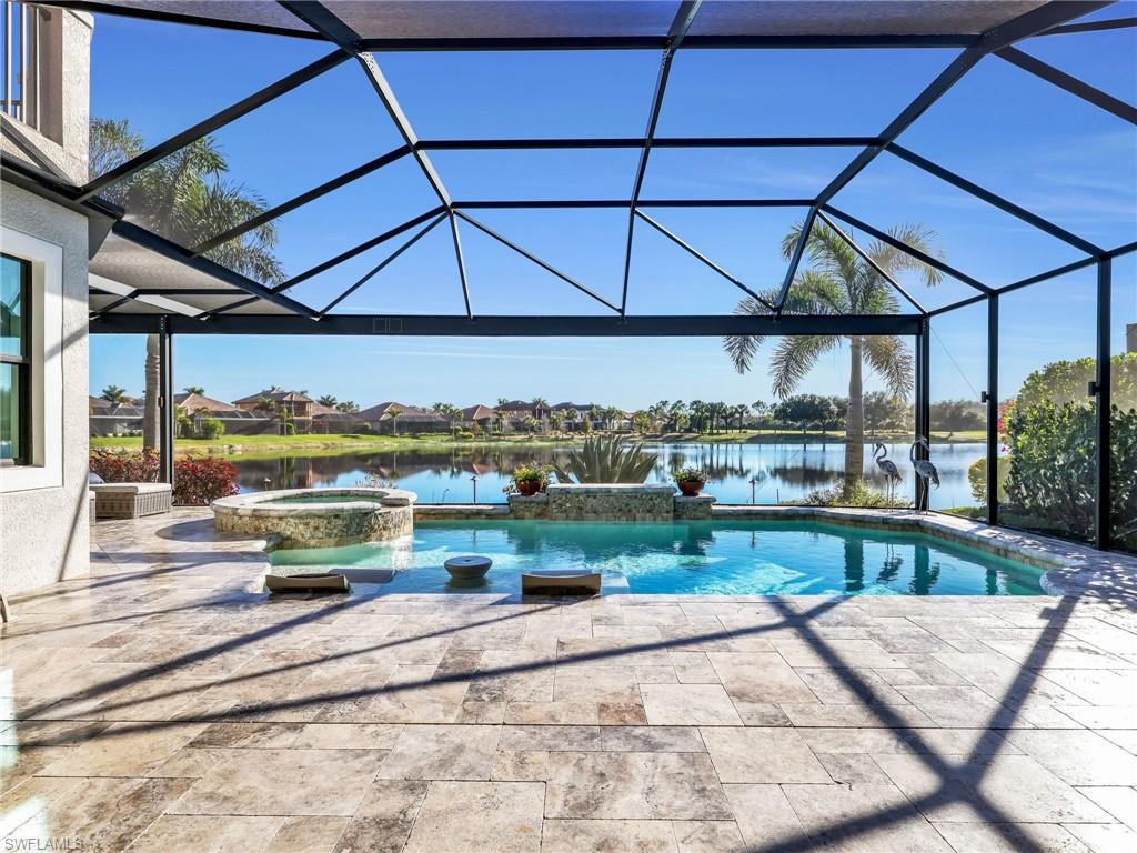 12757 Dundee Lane Naples, FL 34120 - Photo 37 of 48 a view of a swimming pool with a patio