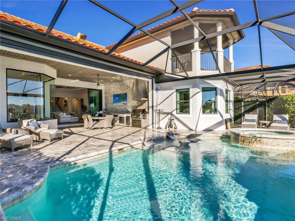 12757 Dundee Lane Naples, FL 34120 - Photo 39 of 48 a view of a backyard with table and chairs under an umbrella