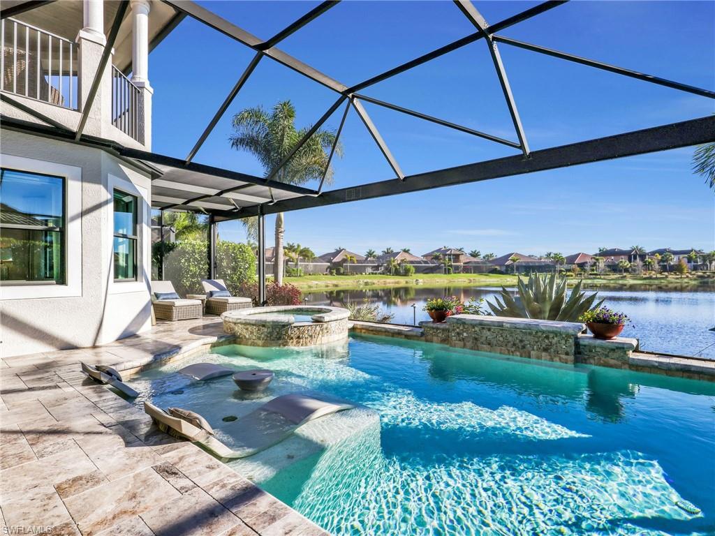 12757 Dundee Lane Naples, FL 34120 - Photo 40 of 48 a view of a swimming pool with a patio