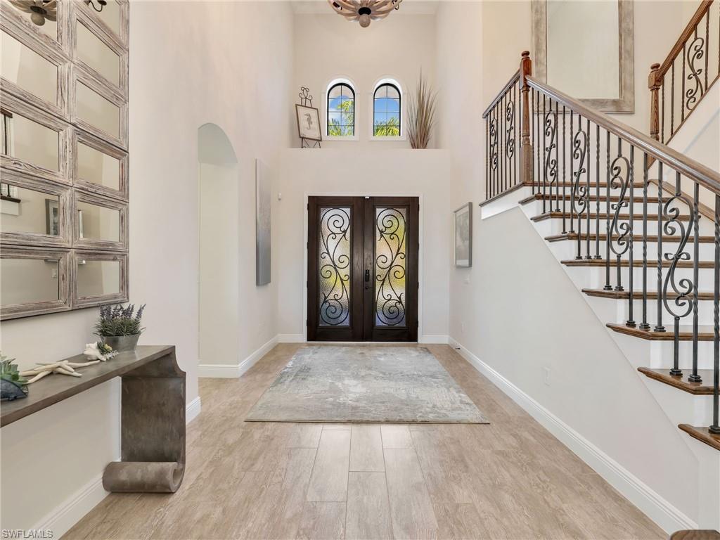 12757 Dundee Lane Naples, FL 34120 - Photo 6 of 48 a view of an entryway with wooden floor