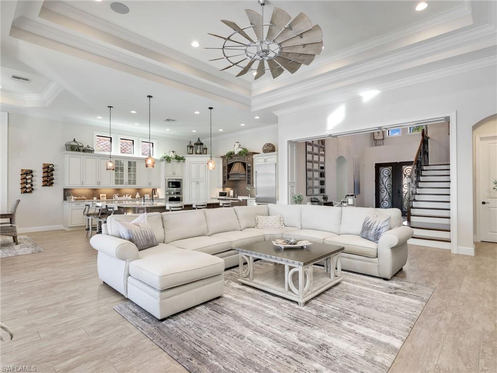 12757 Dundee Lane Naples, FL 34120 - Photo 10 of 48 a living room with furniture and a large window