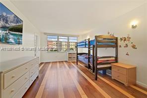 1710 Northeast 191st Street, Unit 2053 Miami, FL 33179 - Photo 5 of 9 a view of a room with wooden floor and furniture