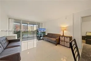 a living room with furniture and a glass door