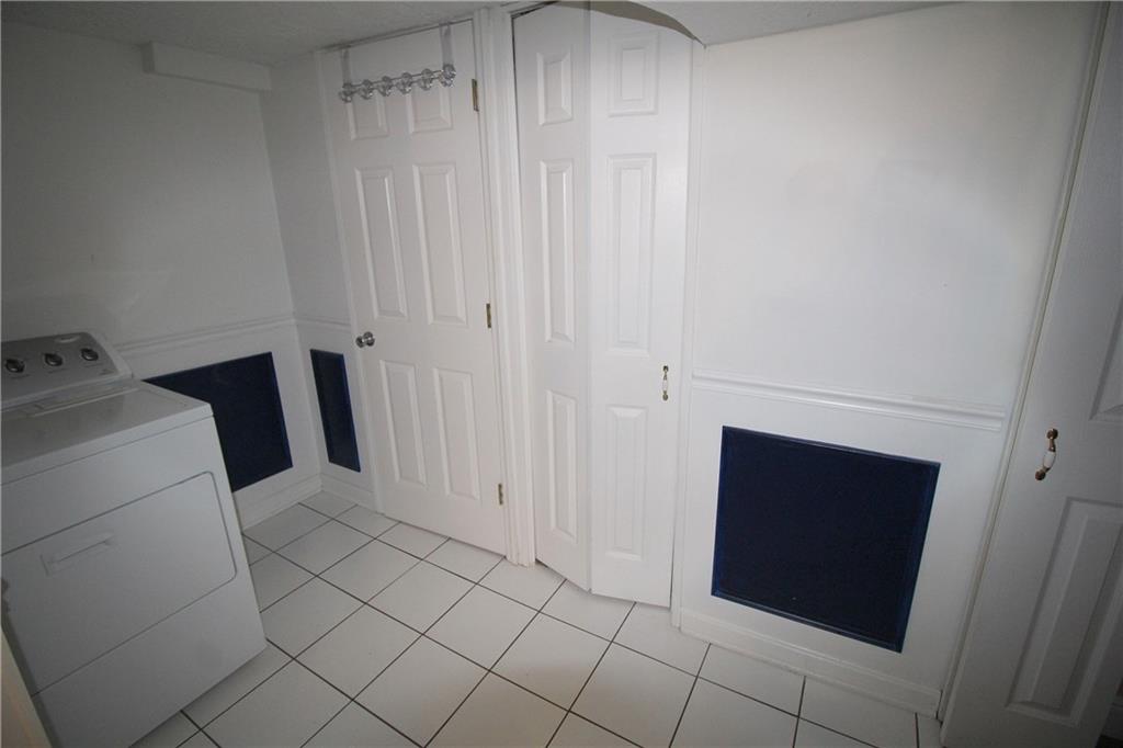 87 Ruthfred Drive Upper St. Clair, PA 15241 - Photo 18 of 21 Tiled laundry area has a half bath and storage.