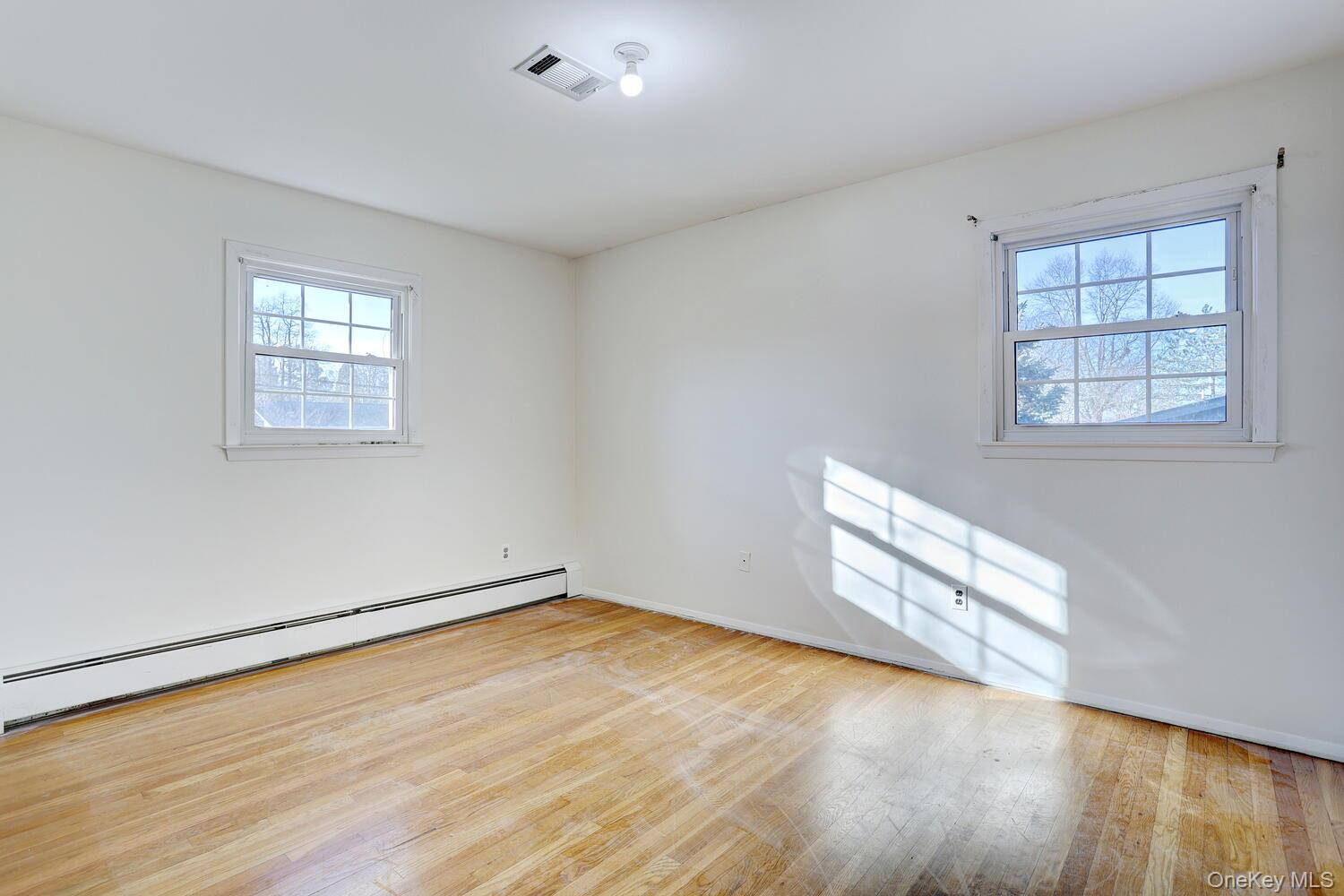 12 Van Gogh Lane Airmont, NY 10901 - Photo 11 of 21 an empty room with wooden floor and windows