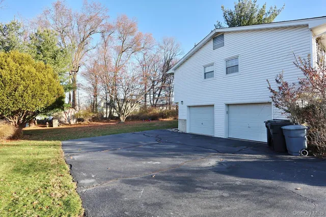 a view of a house with a yard and garage
