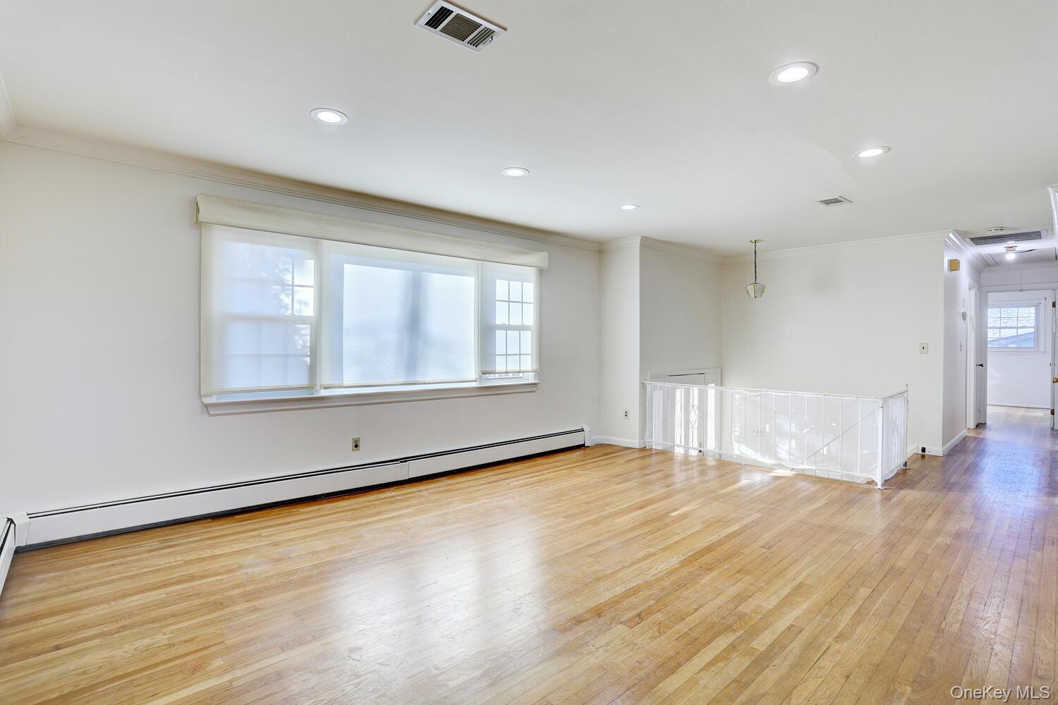 12 Van Gogh Lane Airmont, NY 10901 - Photo 3 of 21 a view of an empty room with wooden floor and a window