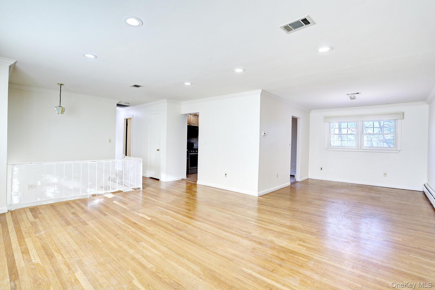 12 Van Gogh Lane Airmont, NY 10901 - Photo 4 of 21 a view of an empty room with wooden floor and a window