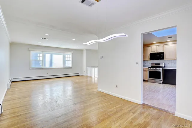 a view of kitchen with sink and wooden floor