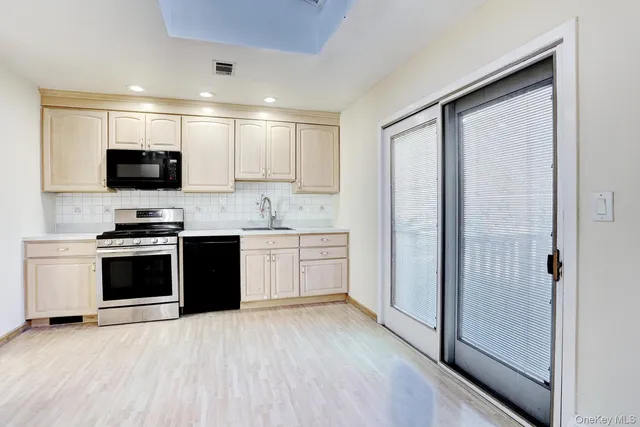 a kitchen with a stove a sink and a refrigerator