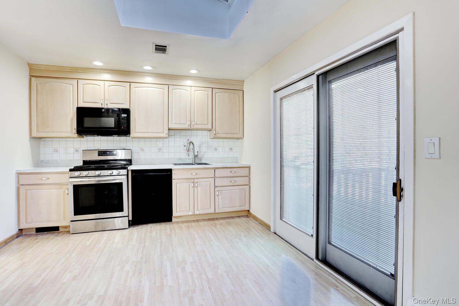 12 Van Gogh Lane Airmont, NY 10901 - Photo 6 of 21 a kitchen with a stove a sink and a refrigerator