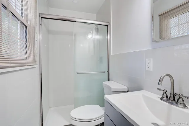 a bathroom with a sink toilet and a mirror