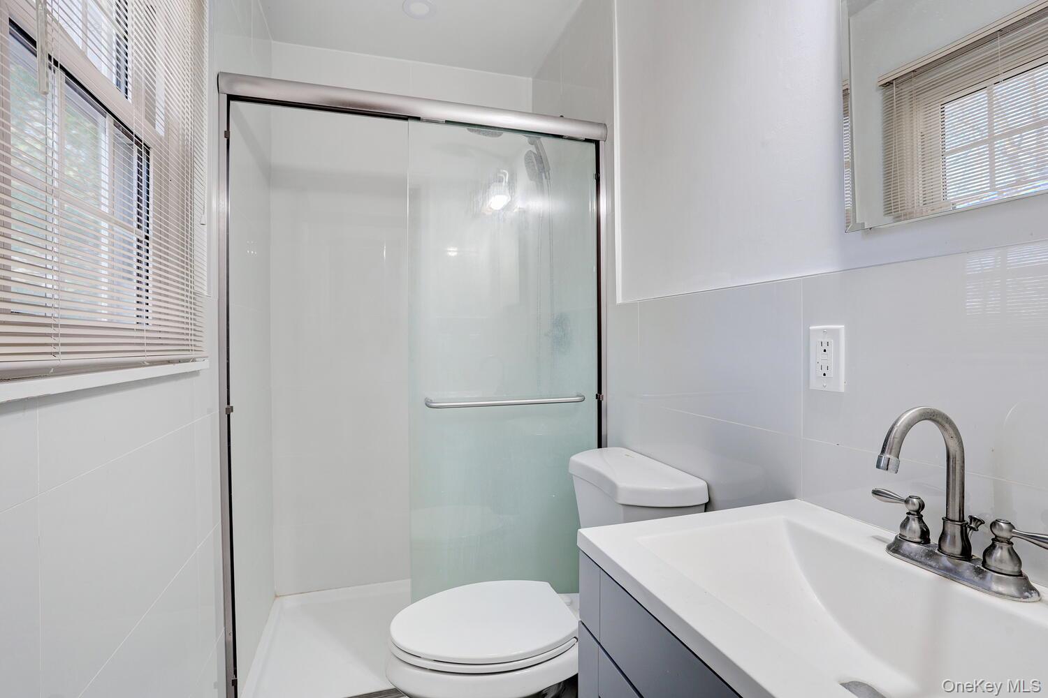 12 Van Gogh Lane Airmont, NY 10901 - Photo 10 of 21 a bathroom with a sink toilet and a mirror