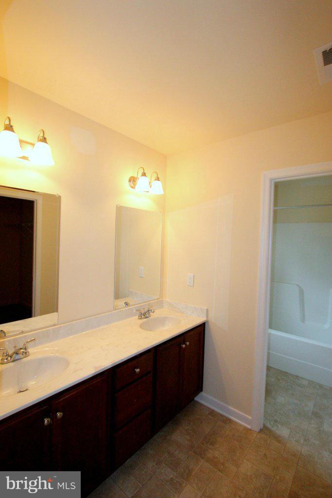 7 Winding Ridge Way Bumpass, VA 23024 - Photo 14 of 21 a bathroom with a double vanity sink and mirror