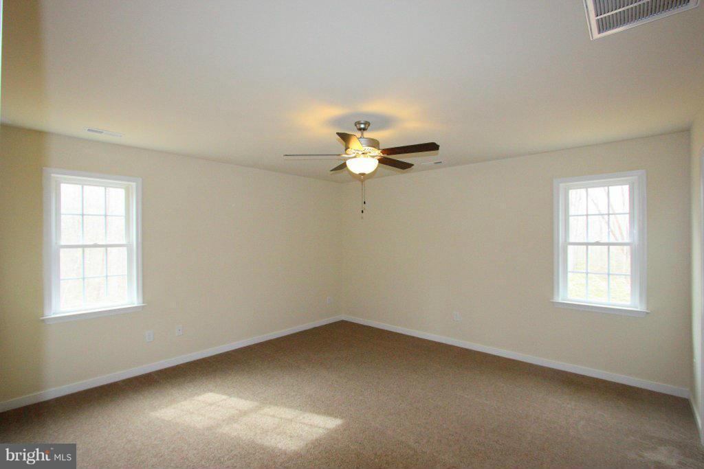 7 Winding Ridge Way Bumpass, VA 23024 - Photo 17 of 21 wooden floor in an empty room with a window