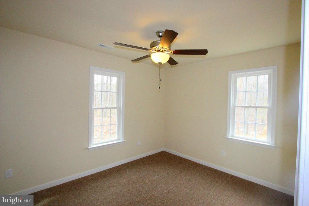 7 Winding Ridge Way Bumpass, VA 23024 - Photo 18 of 21 an empty room with windows and fan