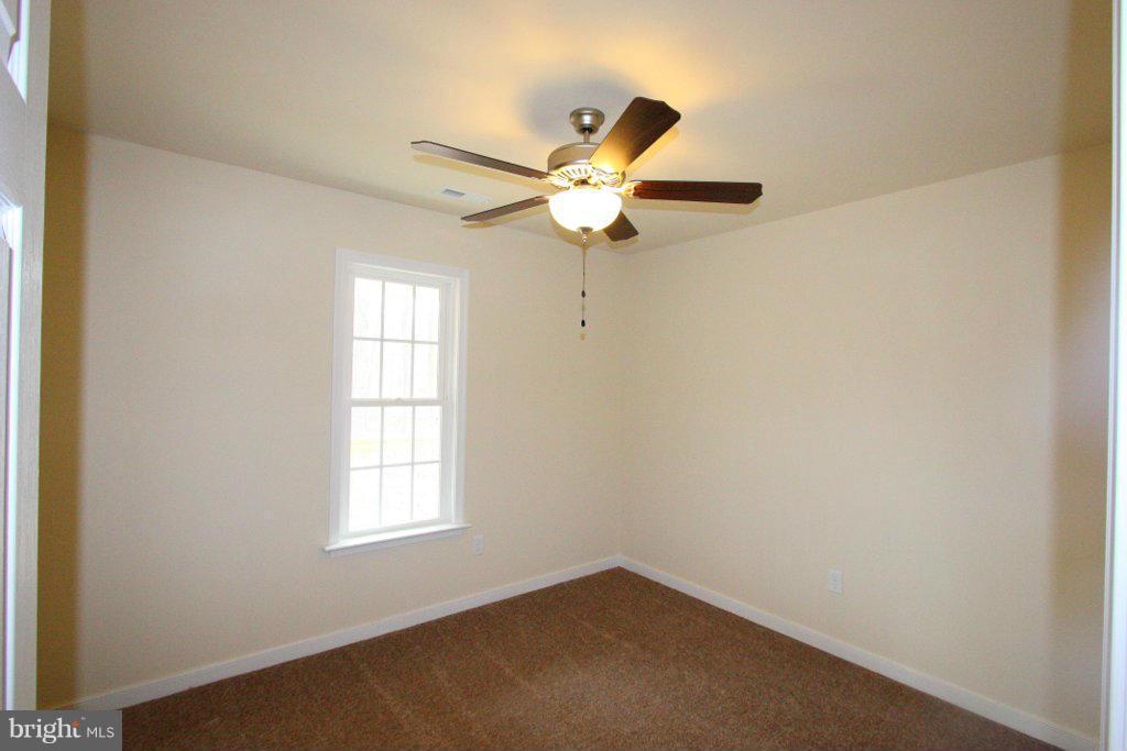 7 Winding Ridge Way Bumpass, VA 23024 - Photo 19 of 21 an empty room with a window and a fan