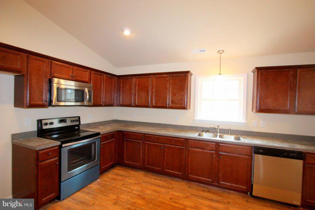 7 Winding Ridge Way Bumpass, VA 23024 - Photo 8 of 21 a kitchen with granite countertop stainless steel appliances a sink a stove cabinets and wooden floor