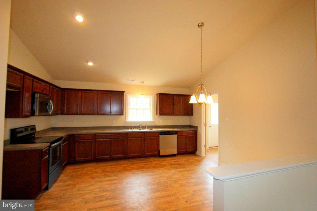 7 Winding Ridge Way Bumpass, VA 23024 - Photo 9 of 21 a kitchen with stainless steel appliances granite countertop a sink and a stove top oven