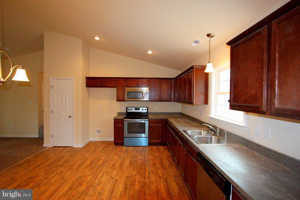 7 Winding Ridge Way Bumpass, VA 23024 - Photo 10 of 21 a kitchen with stainless steel appliances granite countertop a stove a sink dishwasher and a refrigerator with wooden floor