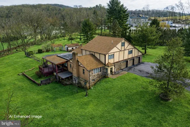 aerial view of a house with a yard table and chairs