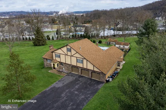 an aerial view of a house next to a yard