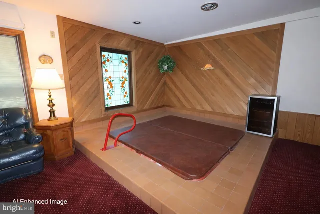 a living room with a bed furniture and a window