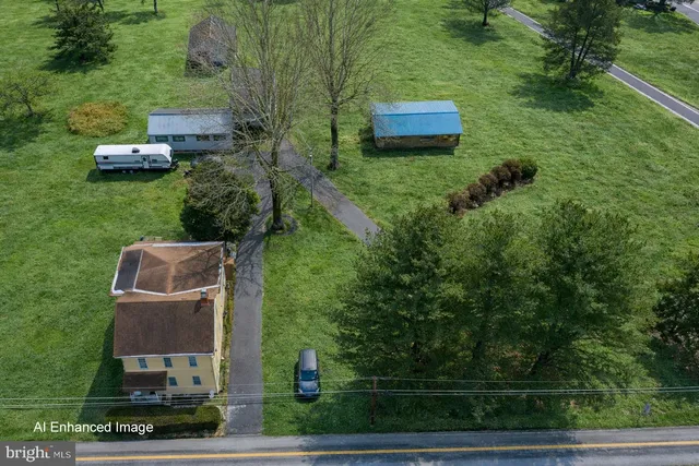 an aerial view of a house with a yard