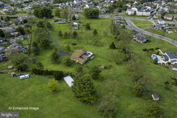 an aerial view of a houses with a yard