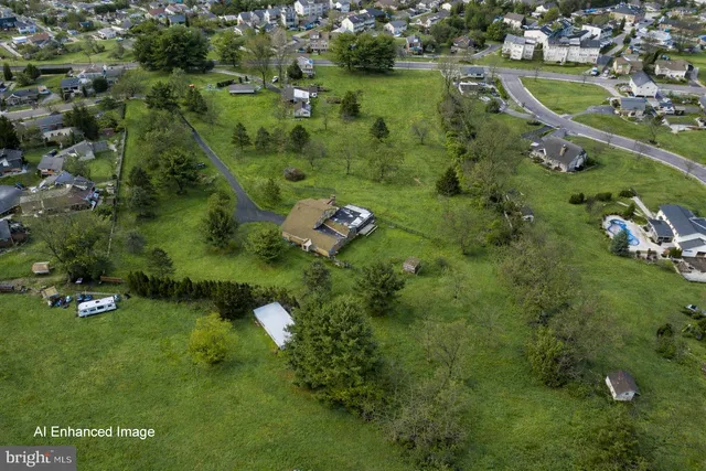 an aerial view of a houses with a yard