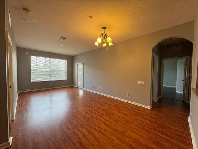 a view of a room with wooden floor and window
