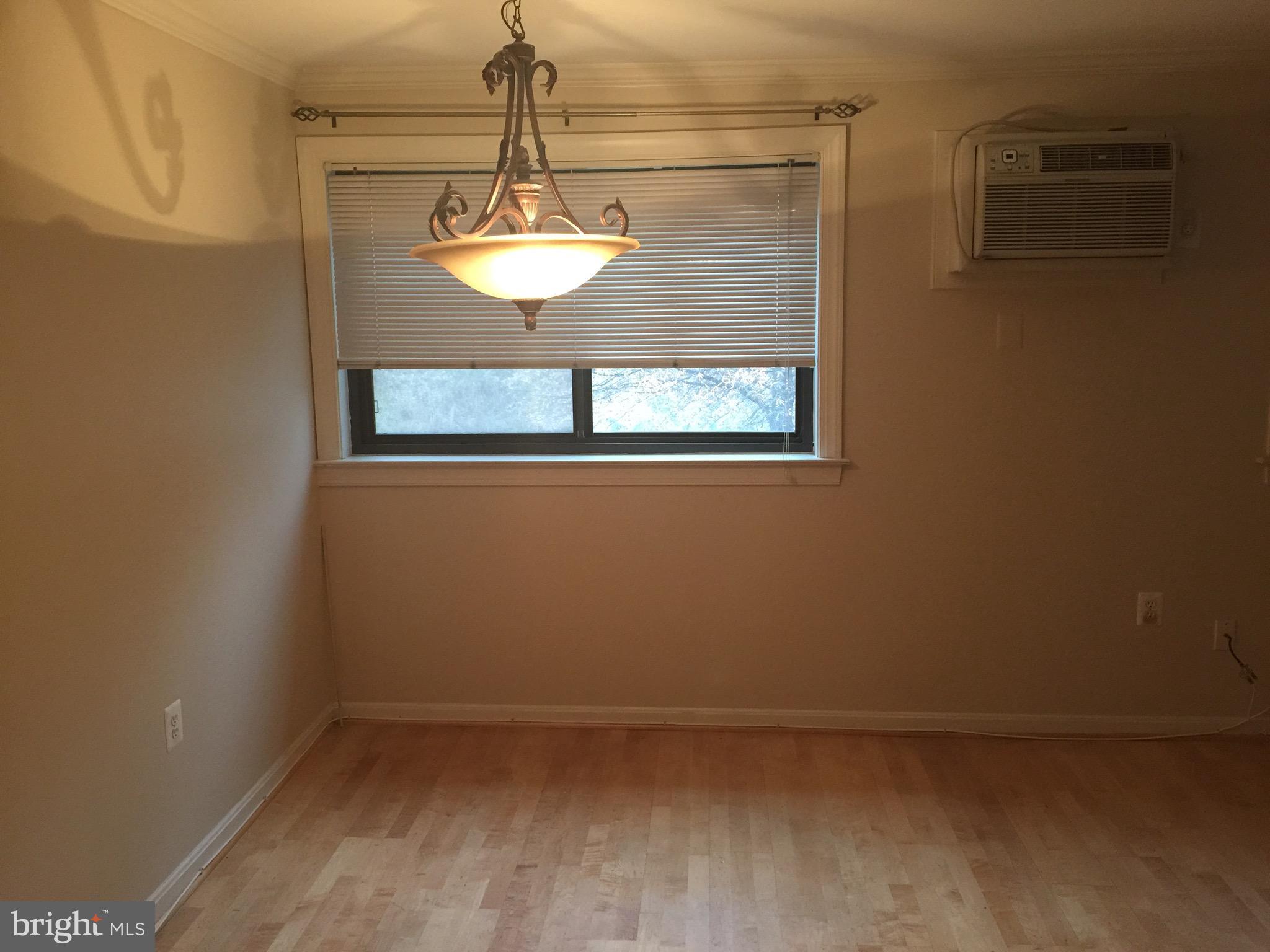 3107 Naylor Road Southeast, Unit 204 Washington, DC 20020 - Photo 4 of 17 a view of a room with a hanging light and kitchen