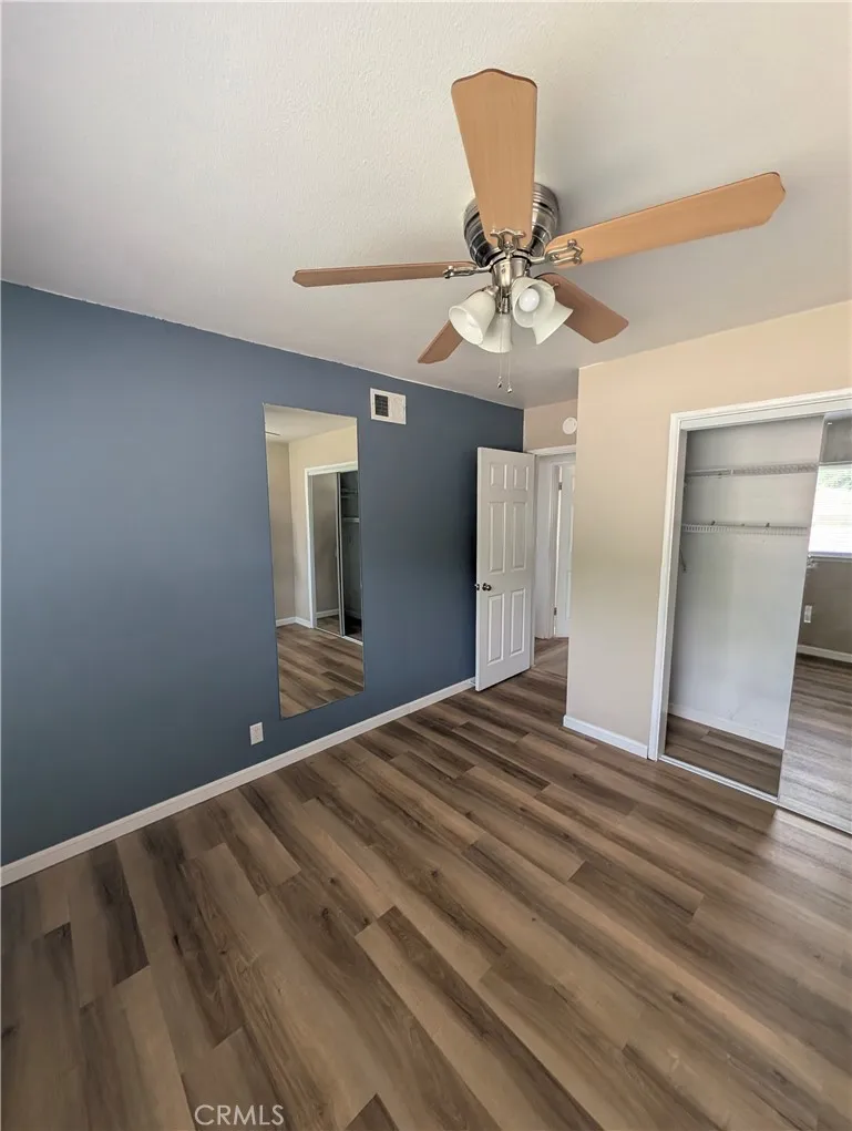 8641 Garfield Street, Unit 1 Riverside, CA 92504 - Photo 9 of 19 a view of a livingroom with a ceiling fan and wooden floor