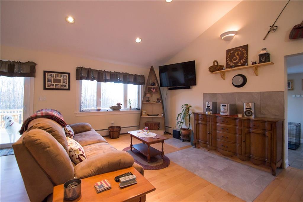 144 Garland Road Shapleigh, ME 04076 - Photo 7 of 33 Living room with chimney and tile in...