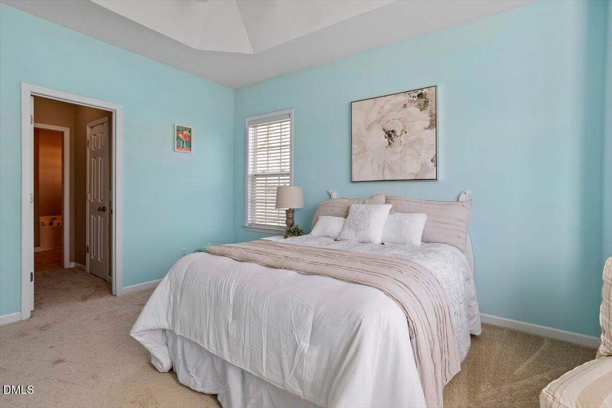 119 Victory Circle Willow Spring, NC 27592 - Photo 10 of 33 a bedroom with a bed and painting on the wall
