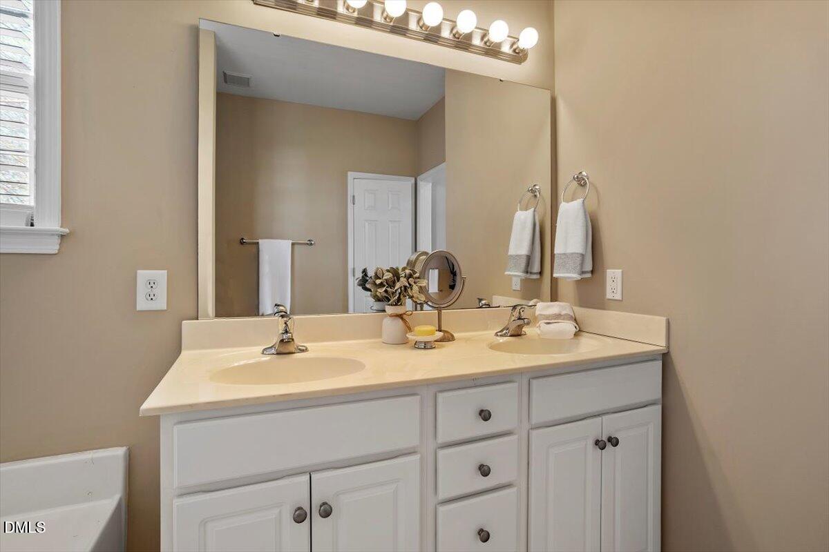 119 Victory Circle Willow Spring, NC 27592 - Photo 13 of 33 a bathroom with a sink vanity and a mirror