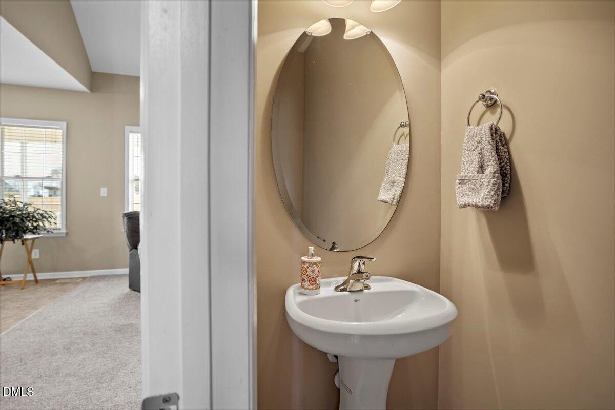 119 Victory Circle Willow Spring, NC 27592 - Photo 14 of 33 a bathroom with a sink and mirror