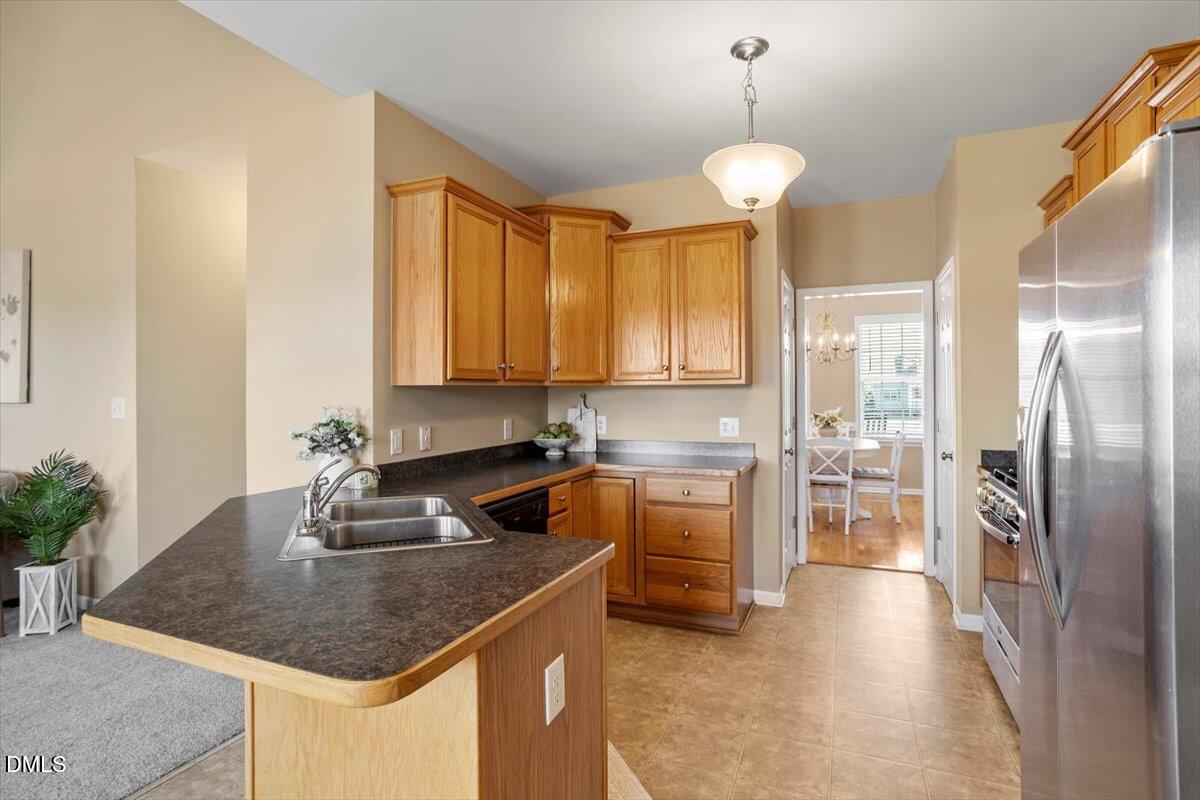 119 Victory Circle Willow Spring, NC 27592 - Photo 20 of 33 a kitchen with stainless steel appliances granite countertop a sink a stove and a refrigerator