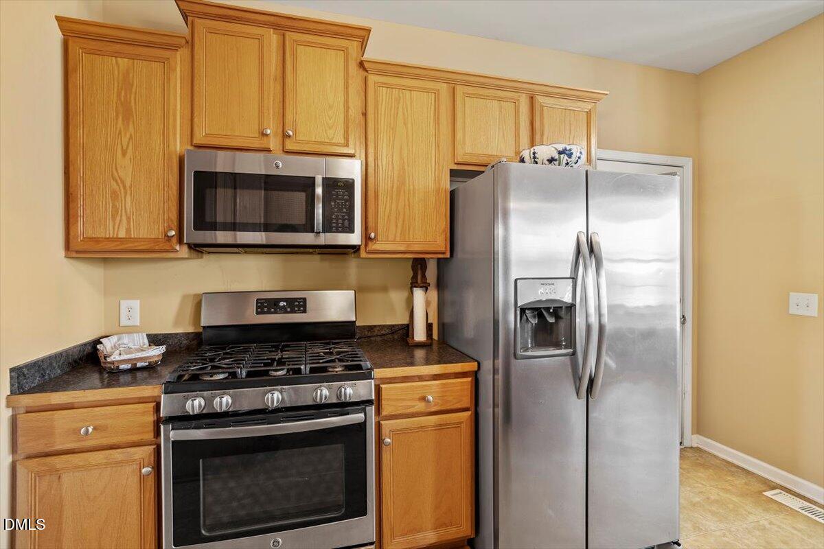 119 Victory Circle Willow Spring, NC 27592 - Photo 22 of 33 a kitchen with a refrigerator stove and microwave