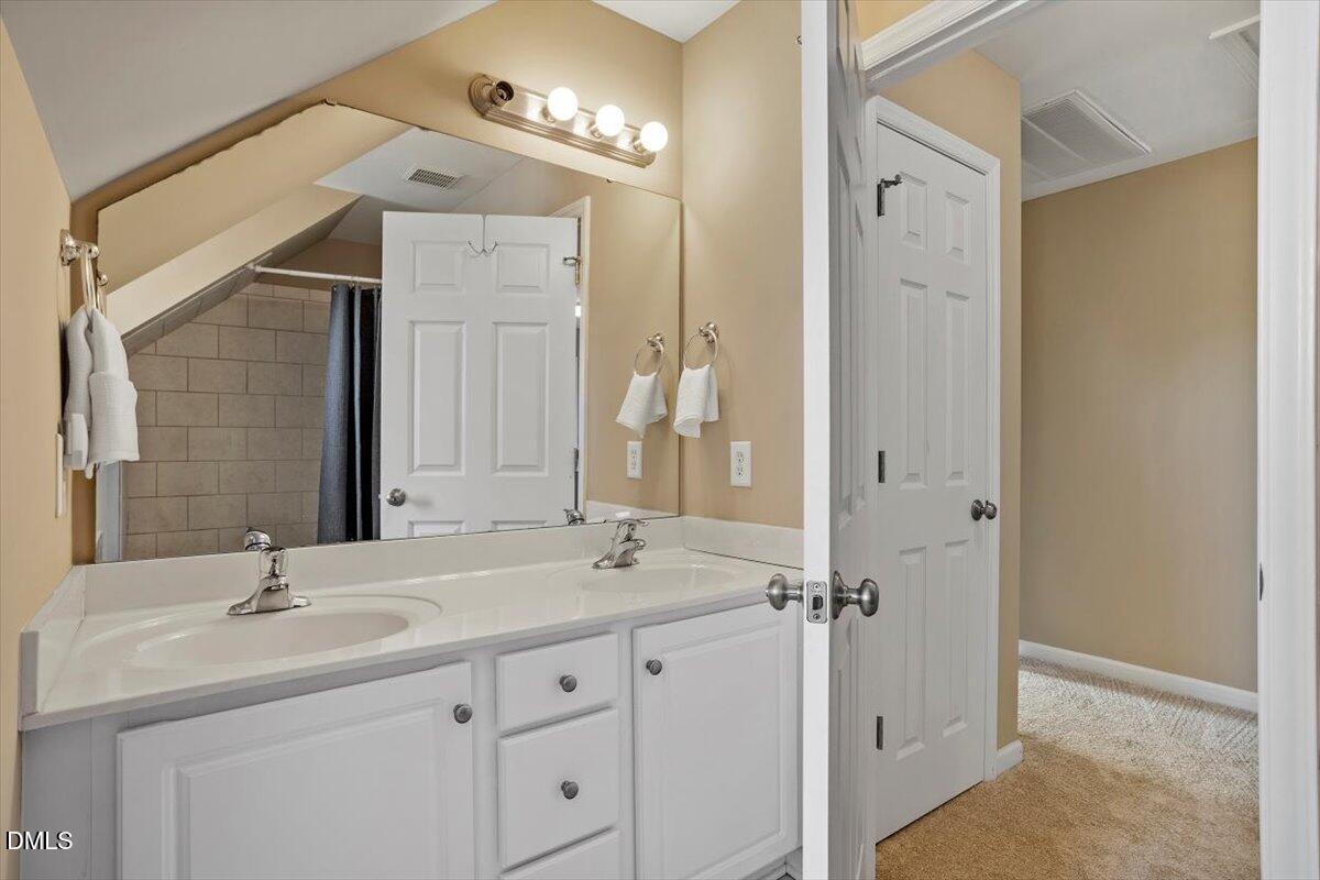 119 Victory Circle Willow Spring, NC 27592 - Photo 26 of 33 a bathroom with a double vanity sink mirror and