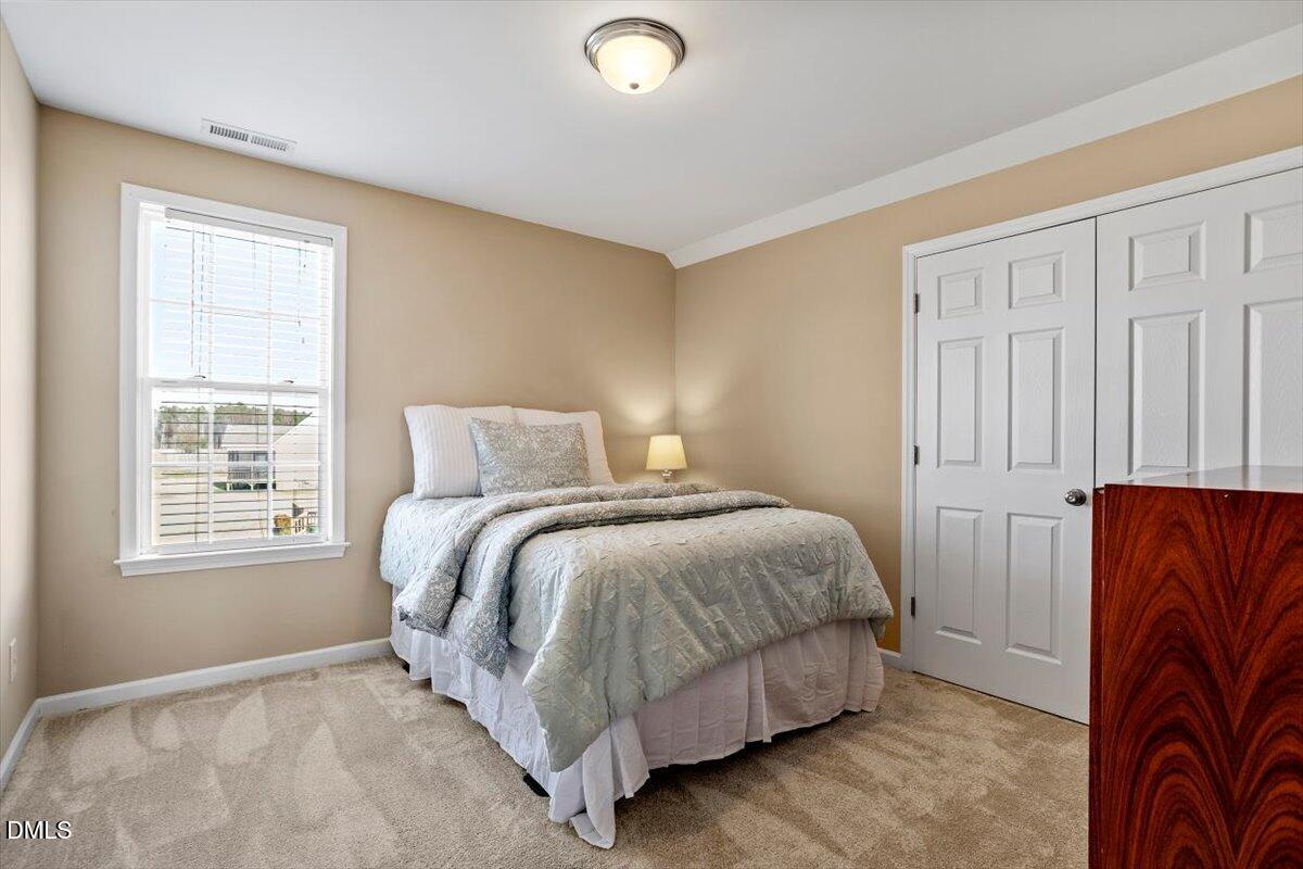 119 Victory Circle Willow Spring, NC 27592 - Photo 28 of 33 a bedroom with a bed and window